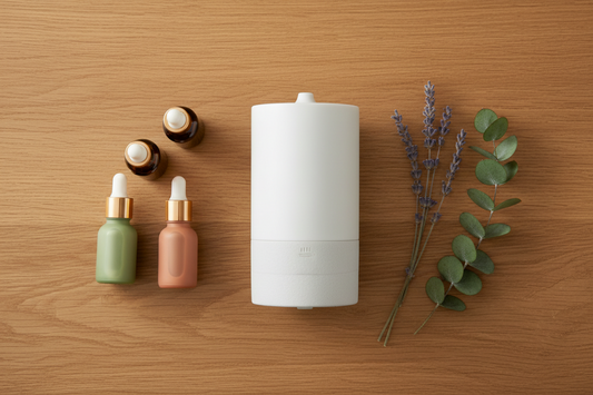 Affordable essential oil diffuser for home fragrance on a wooden shelf with essential oil bottles and dried lavender